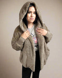 Woman wearing a beige hooded jacket on a white background